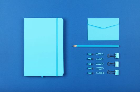 Neatly organized stationery flat lay of blue