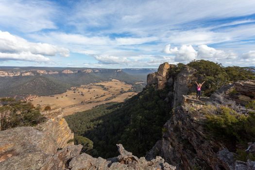 Adventurous hiker explorer reaching the top slab of Donkey Mountain in Australia