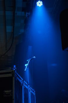 microphone in concert hall with blue lights