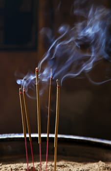 Burning incence sticks in a Buddhist temple