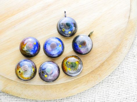 Create galaxy drink coasters using resin, glitter and pigment po