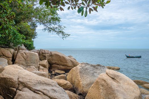 Penang island rocks at beach next to the tropical rain forest of Penang National Park