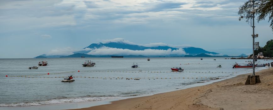 Penang island beach panorama low hanging clouds covering mountains