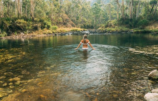 Woman wading in thermal springs in Australia