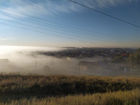 Mystic early Morning village in fog