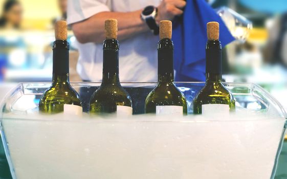 Catering bartender Italian fine wine bottles winetasting session sommelier waiter serving wine people clean glasses background