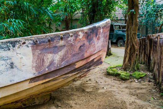 the front a old rowing boat in a tropical jungle scenery, water transportation, nautical background