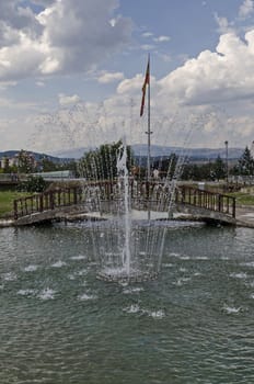 View of artificial pond and fountain close up with beauty drops, town Delchevo among Maleshevo and Osogovo mountains