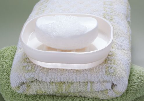 white soap bar and bath towel