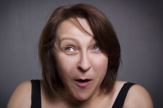 Woman grimaces in front of camera