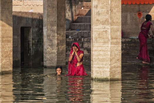 Unidentified Hindu women pilgrims take bath in the Holy river Ga
