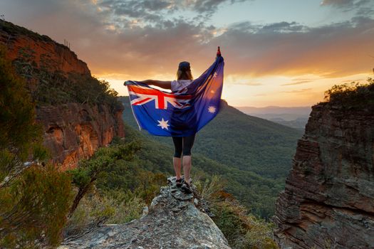 Patriotic woman holding Australian flag in Blue Mountains Australia