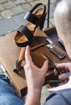 Hands making shoes