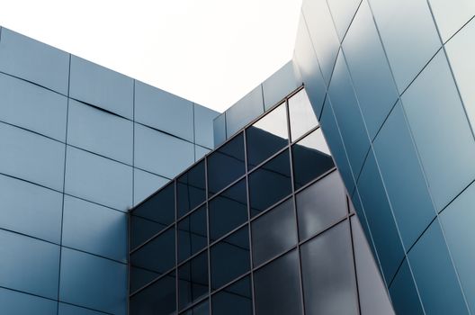 facade of the building with blue panels and reflective surfaces