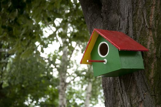Home-made bright colored bird house 