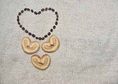 coffee beans heart and heart shaped cookies on beige background