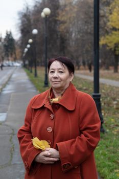 Senior woman in the park in autumn