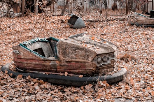 rusty car in an abandoned amusement park in Chernobyl Ukraine