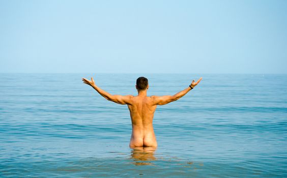 nude man in blue water