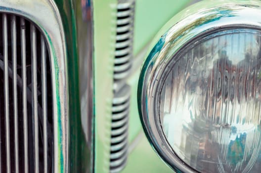 headlight and radiator of an old retro car close up