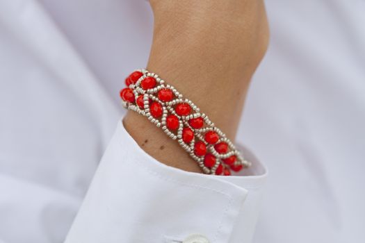 Stylish red bead bracelet on female hand 