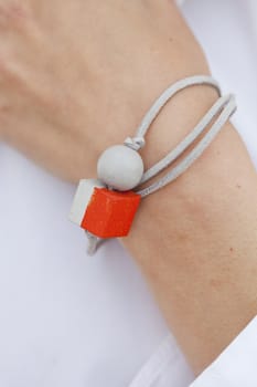 Stylish red and grey bead bracelet on female hand