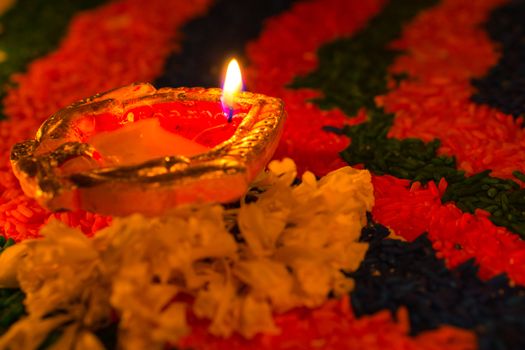 Indian festival Diwali, Diya oil lamps lit on colorful rangoli w