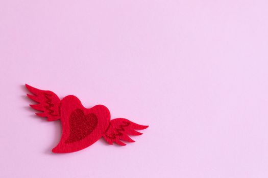 Red felted heart on pink background, St Valentines Day postcard
