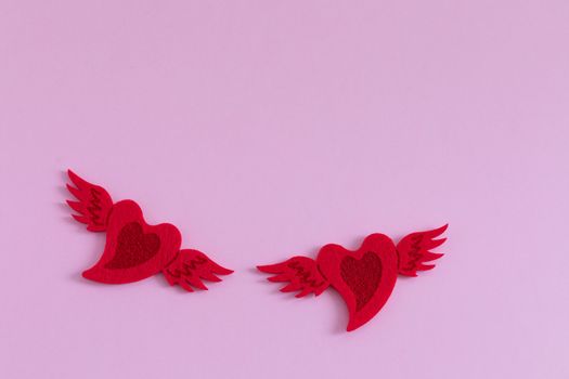 Red felted hearts on pink background, St Valentines Day postcard