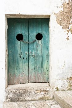 Specchia, Apulia - An old wooden door tightened with a steel tra