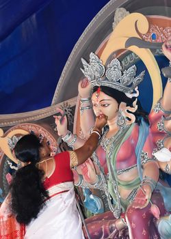 Kolkata October 2019 - Hindu devotee feeding sweets to Maa Durga and wish good luck for her journey back home at Vijaya Dashami in Durga puja Festival. A sorrowful ritual to bid farewell to the deity.