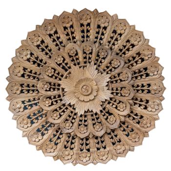 Wooden pattern of flower on carve teak wood in circle shape.