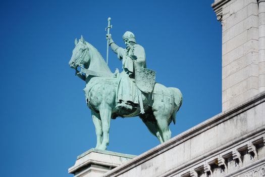 Bronze equestrian statue of King Saint Louis IX on the exterior of the Sacre Coeur basilica in Paris, France