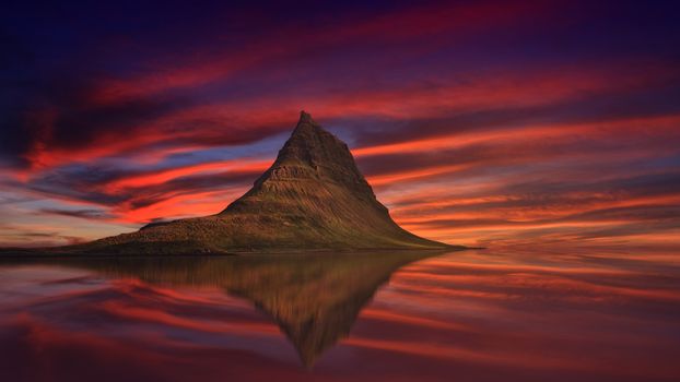 Aerial view of Kirkjufell mountain with beautiful aurora borealis in winter, Iceland. One of the famous natural heritage in Iceland.