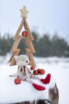 Simple Christmas tree in snow with baubles and christmas decorat