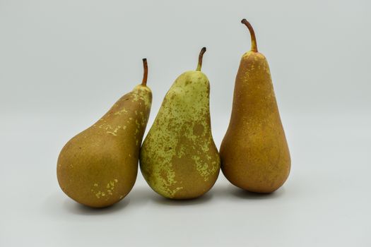 Three pears in a cardboard box isolated on white background
