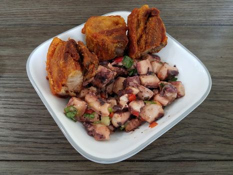 octopus salad and fried pork Puerto Rican food in white bowl
