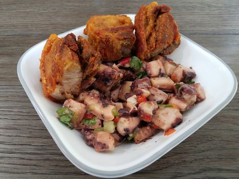 octopus salad and fried pork Puerto Rican food in white bowl