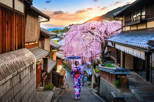 Woman wearing japanese traditional kimono walking at Historic Higashiyama district in spring, Kyoto in Japan.