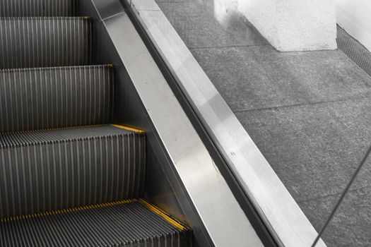 Ditry stairs on Escalator with yellow strips.