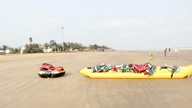 Inflatable adventurous fly fish raft of Fun Jet Ski watercraft wave runner vehicle placed in an empty sea beach for Jet skiing Water sports enthusiast at Goa Sea Beach, India South Asia Pac July 2019