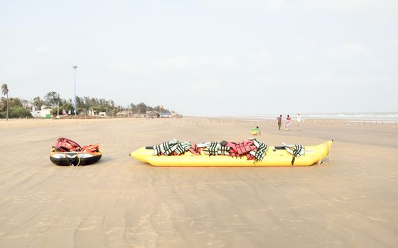 Inflatable adventurous fly fish raft of Fun Jet Ski watercraft wave runner vehicle placed in an empty sea beach for Jet skiing Water sports enthusiast at Goa Sea Beach, India South Asia Pac July 2019