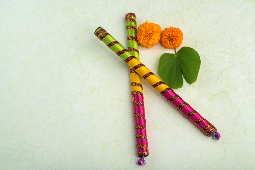 Indian Festival Dussehra, showing golden leaf (Bauhinia racemosa) and marigold flowers with Dandiya sticks.