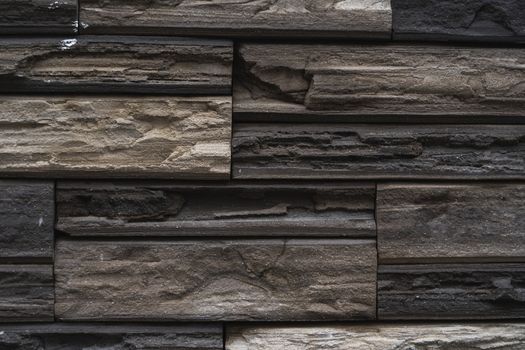 Natural stone bricks as a decoration on a wall. Natural stone wall texture. The walls are made of stones or marbles. Decoration for the walls or febces.
