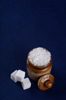 Sugar. white granulated sugar and refined sugar on a blue background
