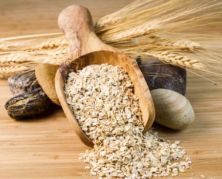 Wooden spoon filled with Raw Rolled Oats 