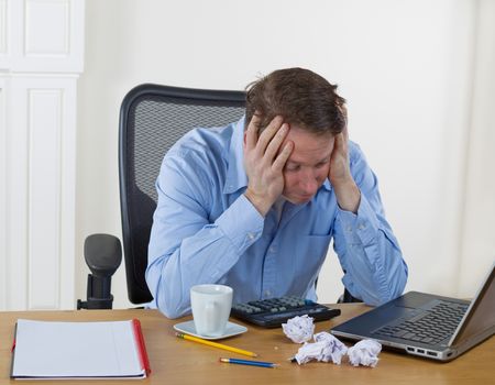 Mature man showing frustration while working 