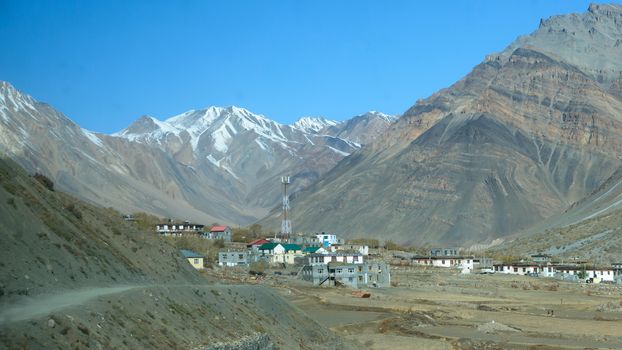 Village at Foothill of Himalayas. Small Villages In The Foothills Of Himalayan picturesque valley. A beautiful indian landscape of a town city at foothills of snow capped Mountain ranges. Kaza India