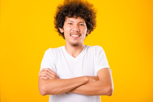 Portrait of Asian handsome man with curly hair with arms crossed