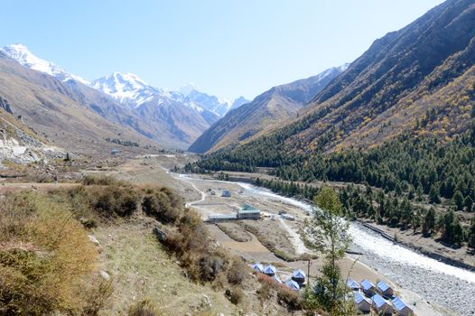 Landscape of mountain valley, panorama of city Sangla Valley, Chitkul village, from the hiking trail in Himalayas Mountains, in summer. Himachal Pradesh India, November 15, 2020